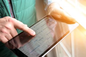 Person using tablet to review logistics or scheduling data