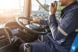 Truck driver using radio while driving commercial vehicle
